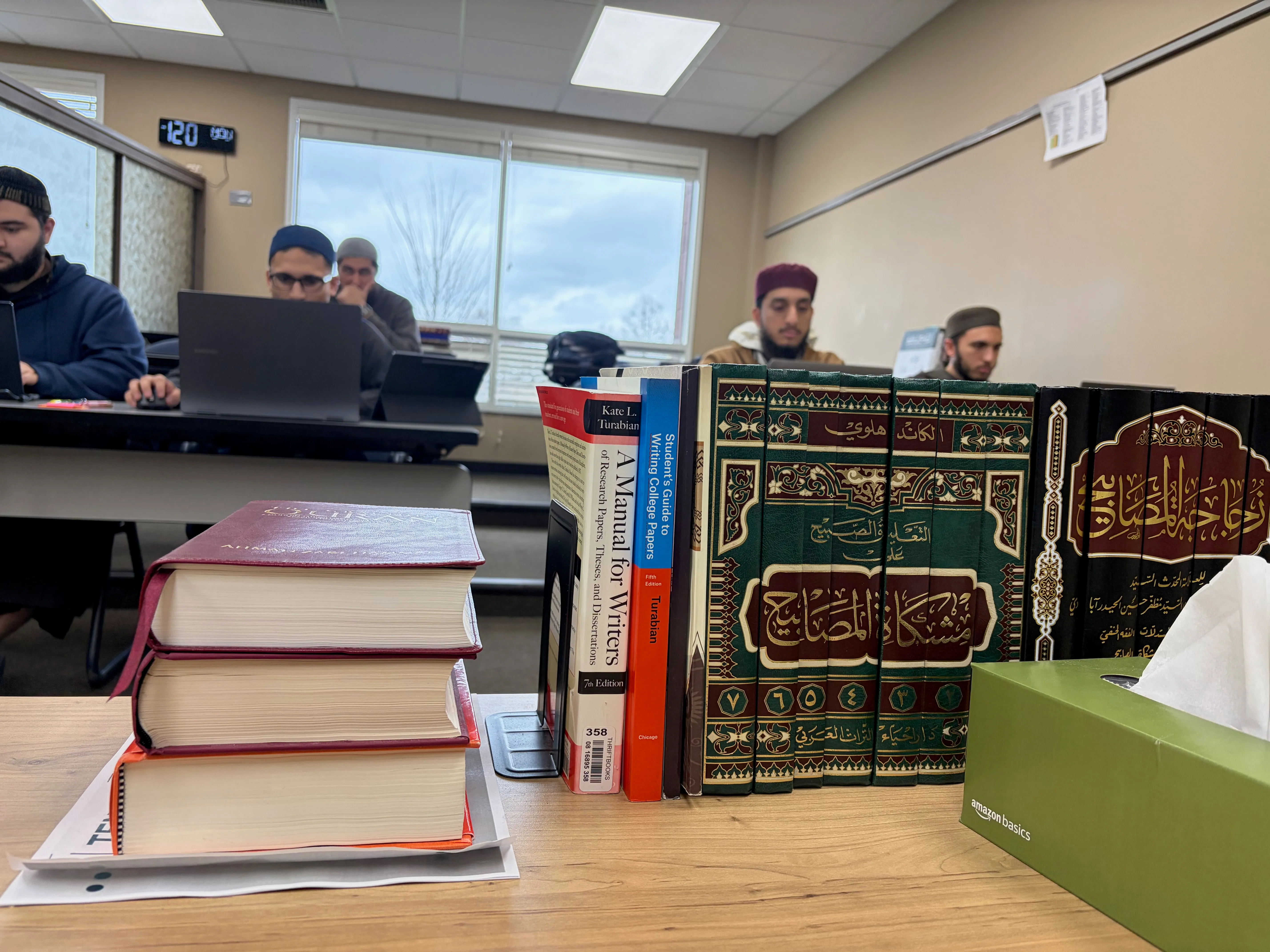 Books on Islamic law, theology and ethics sit on a desk at Darul Qasim, where a growing number of professionals are returning to classical scholarship
